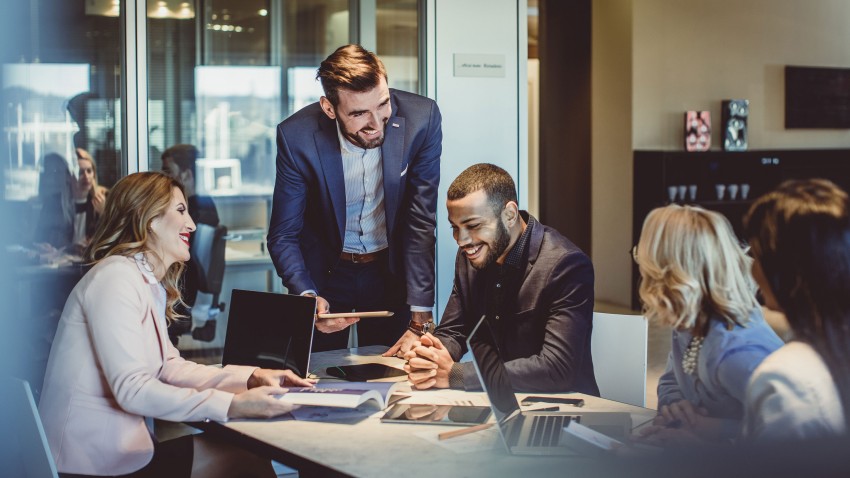 Individuals sitting around table in business meeting