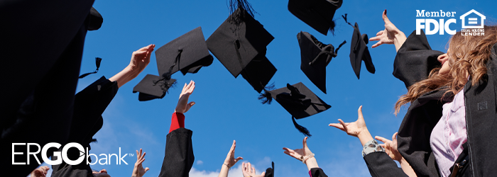 Black graduation caps being thrown into the air by students