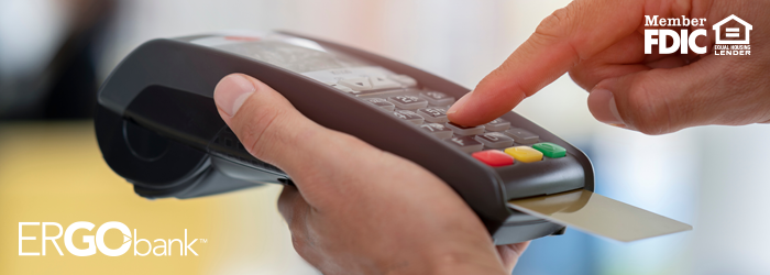 Image shows person entering information in handheld card reader