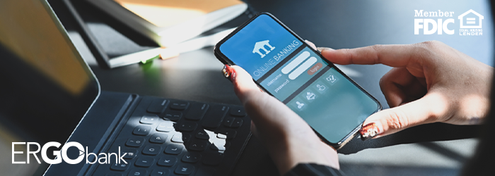 Person holding smartphone with mobile online banking app pulled up