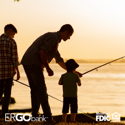 Image shows adult and two children fishing at a lake