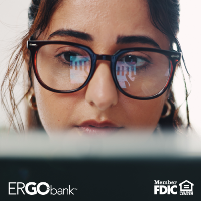 Close up on girl with glasses looking at a computer screen