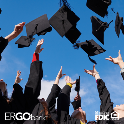 Black graduation caps being thrown into the air by students