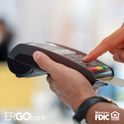 Image shows person entering information in handheld card reader