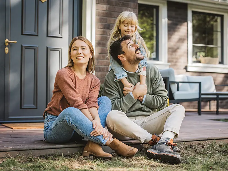family in front of house